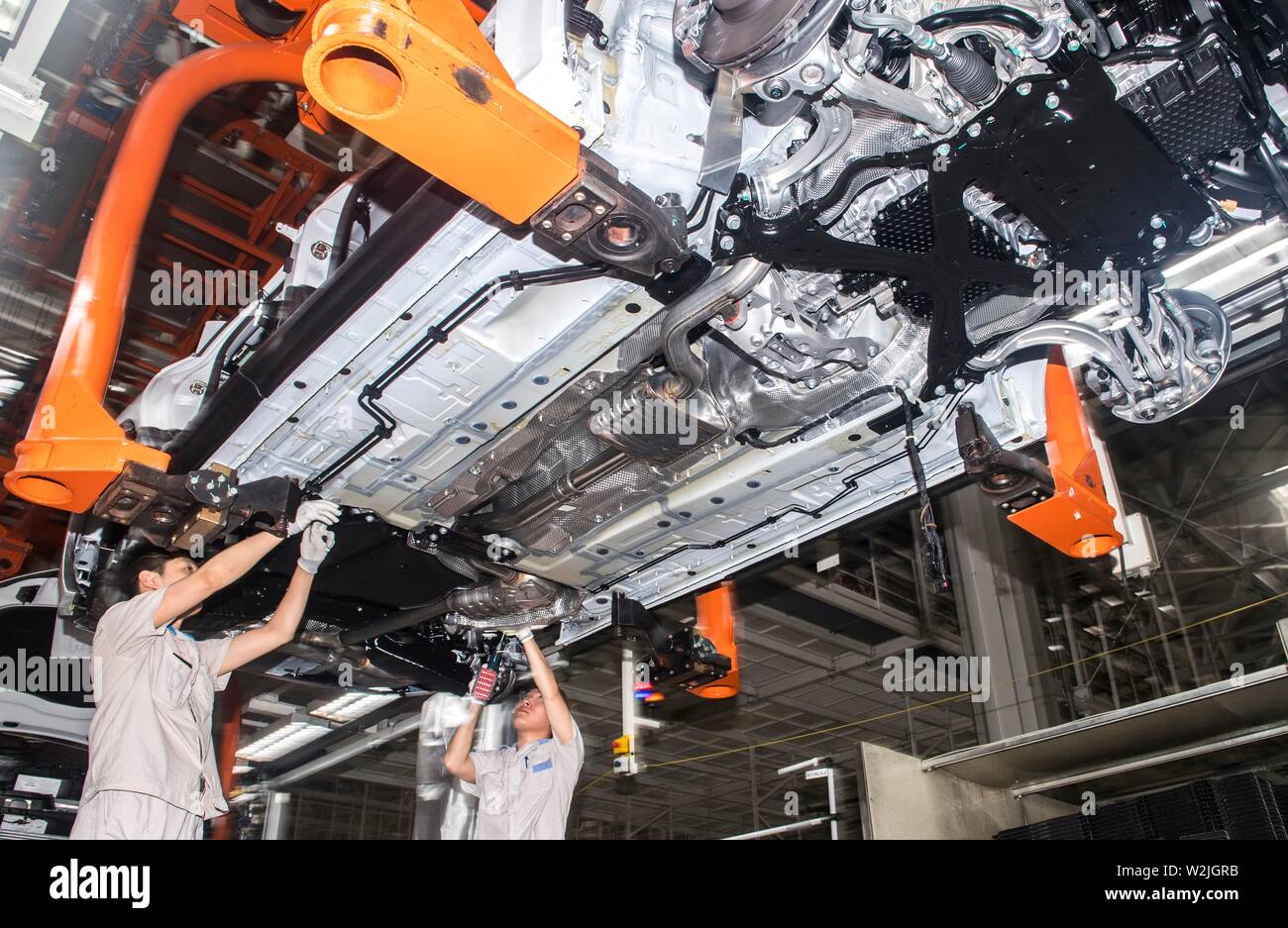 Changchun, China's Jilin Province. 9th July, 2019. Workers assemble an Audi vehicle at FAW-Volkswagen factory in Changchun, northeast China's Jilin Province, July 9, 2019. The Sino-German auto joint venture FAW-Volkswagen said a record 311,871 Audi vehicles were sold in China in the first half of 2019, up 2.1 percent year-on-year. Credit: Xu Chang/Xinhua/Alamy Live News Stock Photo