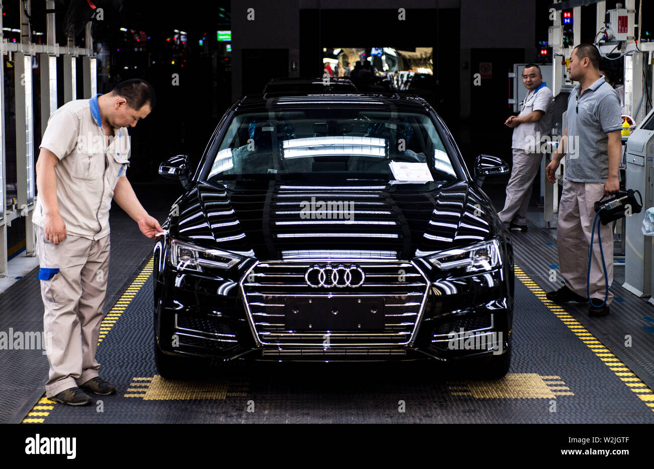 Changchun, China's Jilin Province. 9th July, 2019. Workers check an Audi car at FAW-Volkswagen factory in Changchun, northeast China's Jilin Province, July 9, 2019. The Sino-German auto joint venture FAW-Volkswagen said a record 311,871 Audi vehicles were sold in China in the first half of 2019, up 2.1 percent year-on-year. Credit: Xu Chang/Xinhua/Alamy Live News Stock Photo