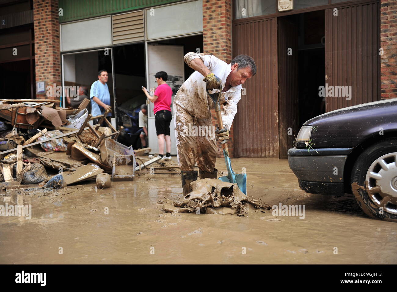 A neighbour draws water from his premises, after the disaster.Floods caused by the meteorological phenomenon called DANA, Isolated Depression in High Levels that resulted in an increase of the water level of the River Cidacos by 4 meters in ten minutes. Stock Photo