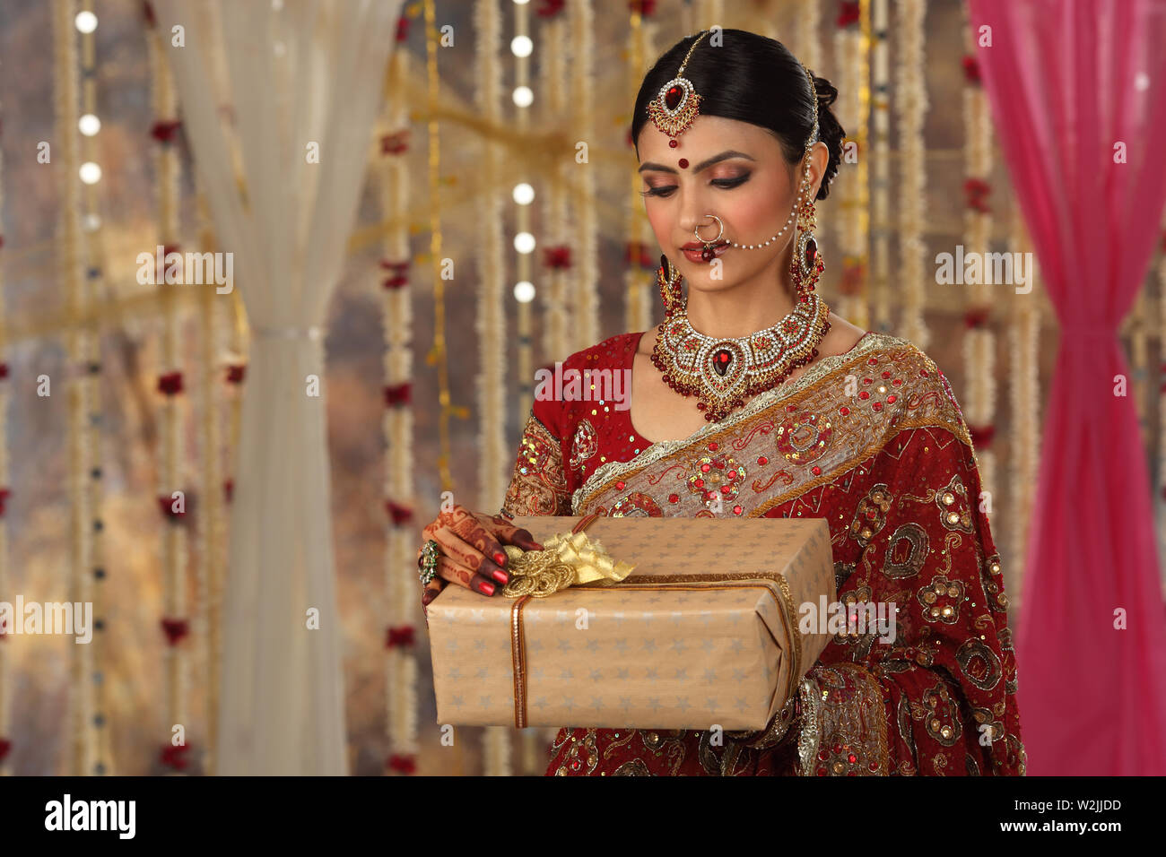 Indian bride holding gift boxes Stock Photo