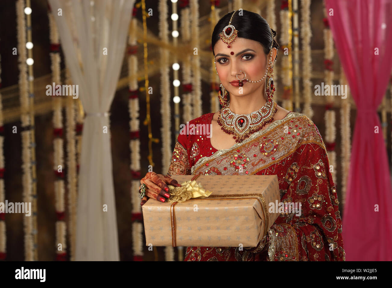 Portrait of an Indian bride holding a gift Stock Photo