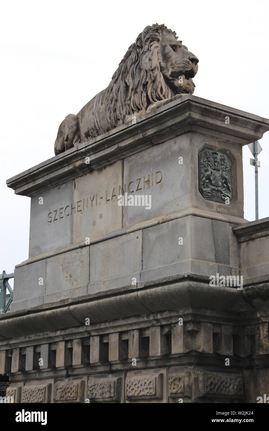 One of four lions at the ends of the famous landmark chain bridge (szechenyi lanczhid) in Budapest, Hungary. Stock Photo
