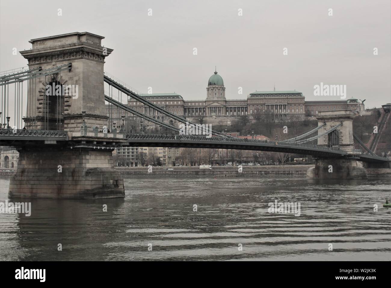 A view of the Széchenyi Lanczhid chain bridge and the Royal Palace of Buda Castle, taken from the Pest side of the river Danube. Stock Photo