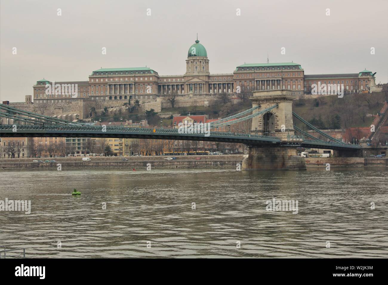 A view of the Széchenyi Lanczhid chain bridge and the Royal Palace of Buda Castle, taken from the Pest side of the river Danube. Stock Photo