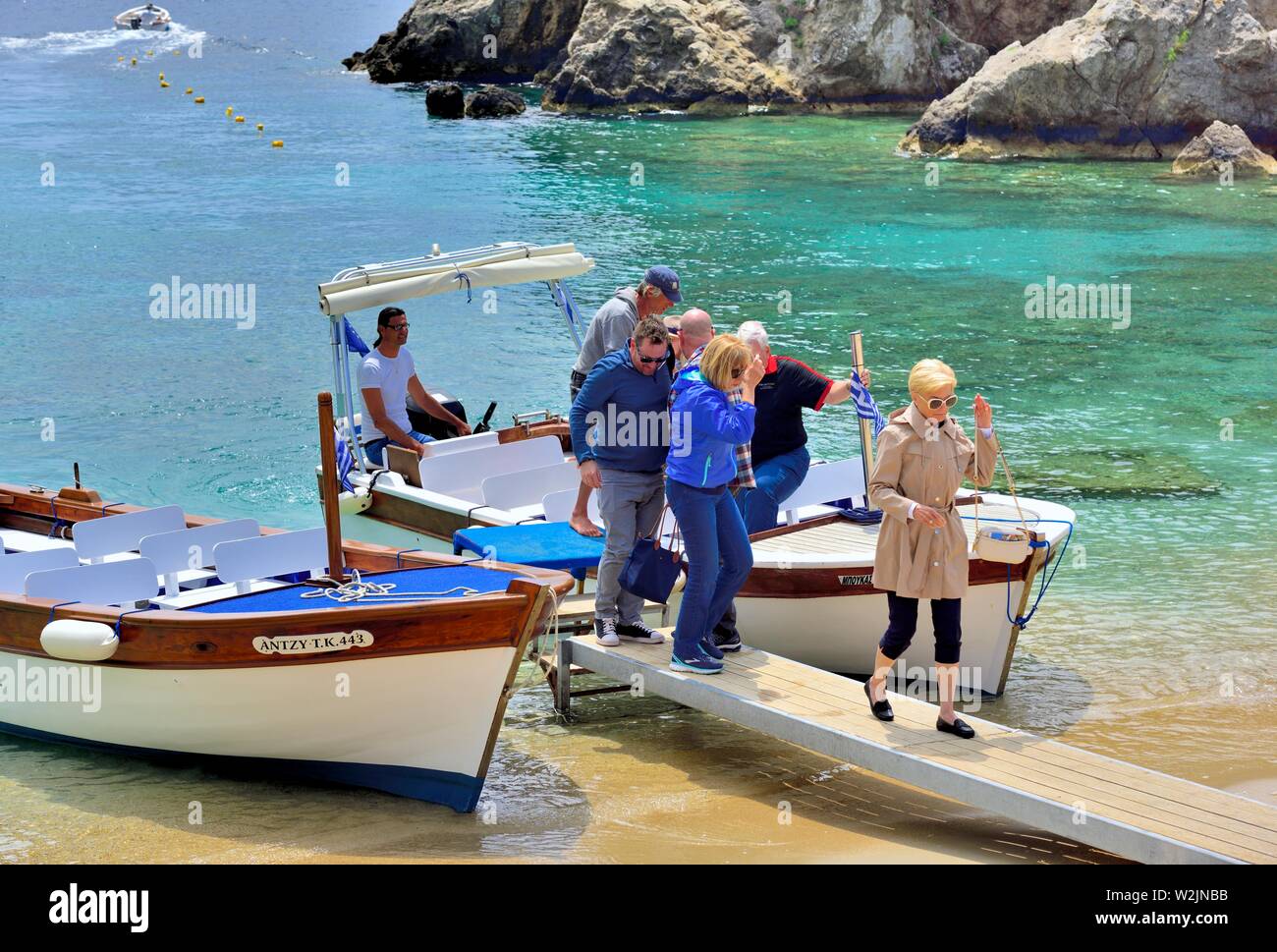 Tourists wearing coats and jackets on a hot sunny day,Agios Spiridon Beach,Agios Spiridon Bay,Paleokastritsa ,Corfu,Greece, Stock Photo