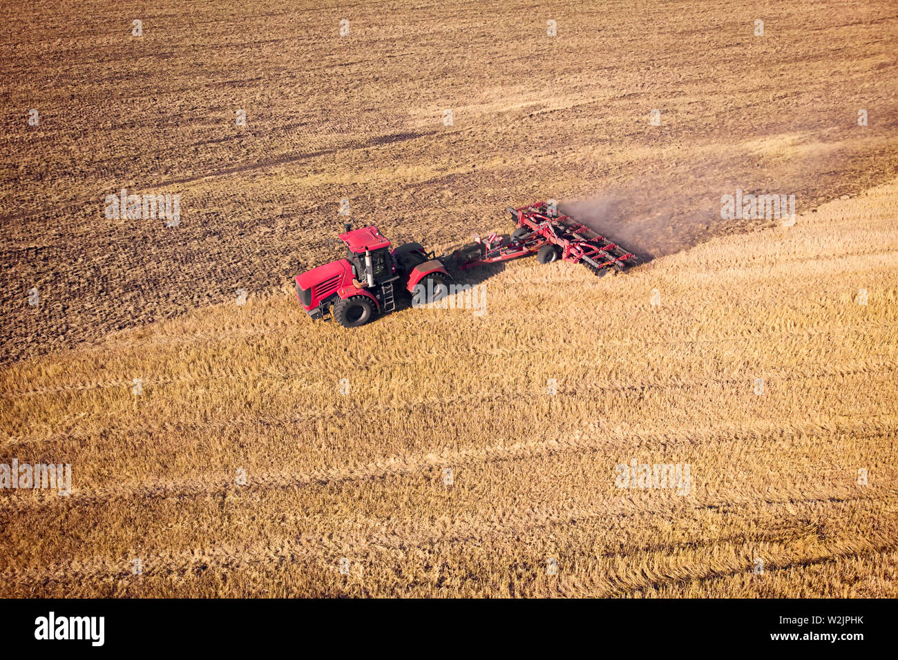 Tractor Working in the Fields, Aerial View. Hay on the field. The view from the top. Tractor harvests dry grass Stock Photo