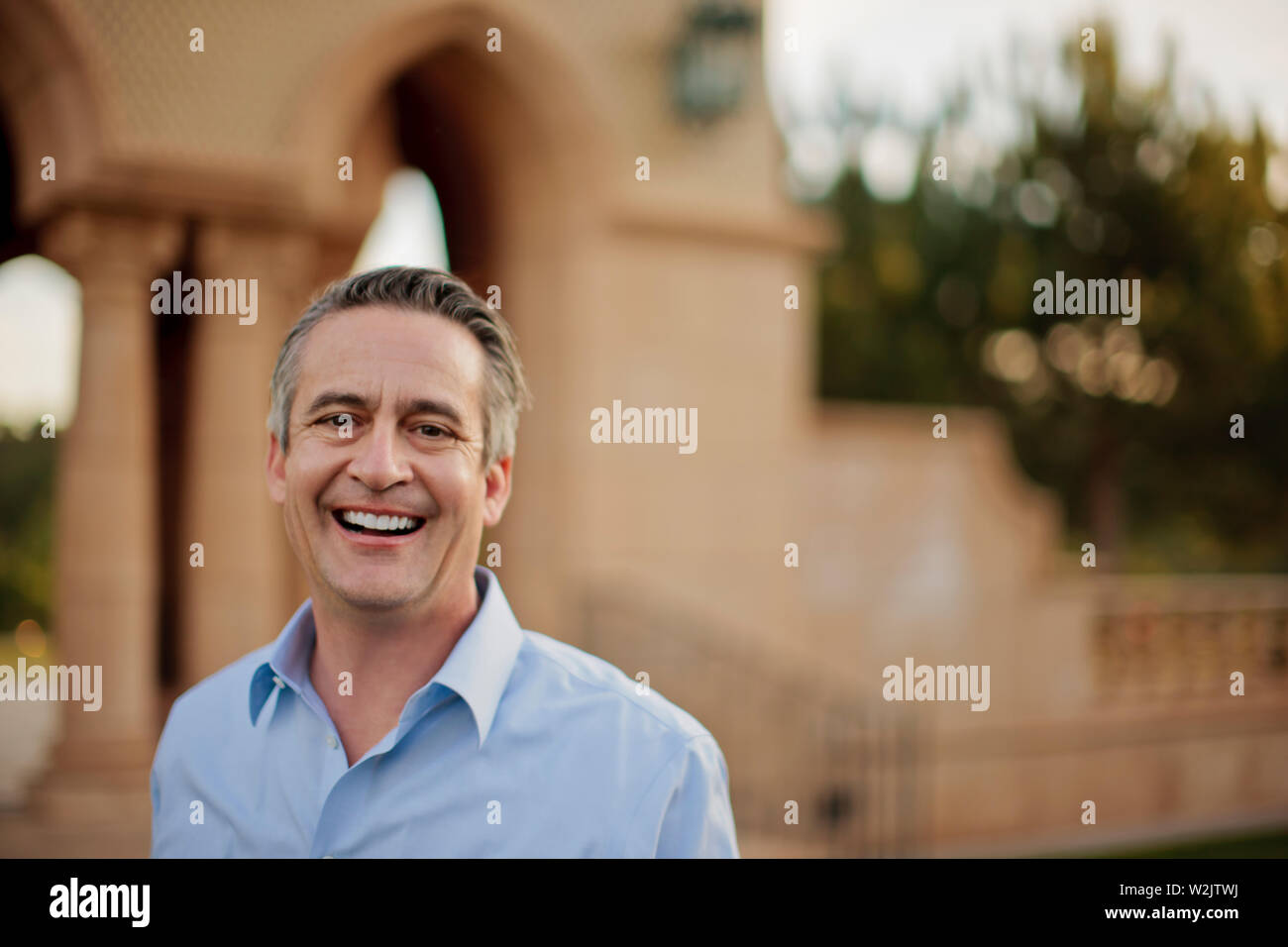 Portrait of a man in front of a grand home. Stock Photo