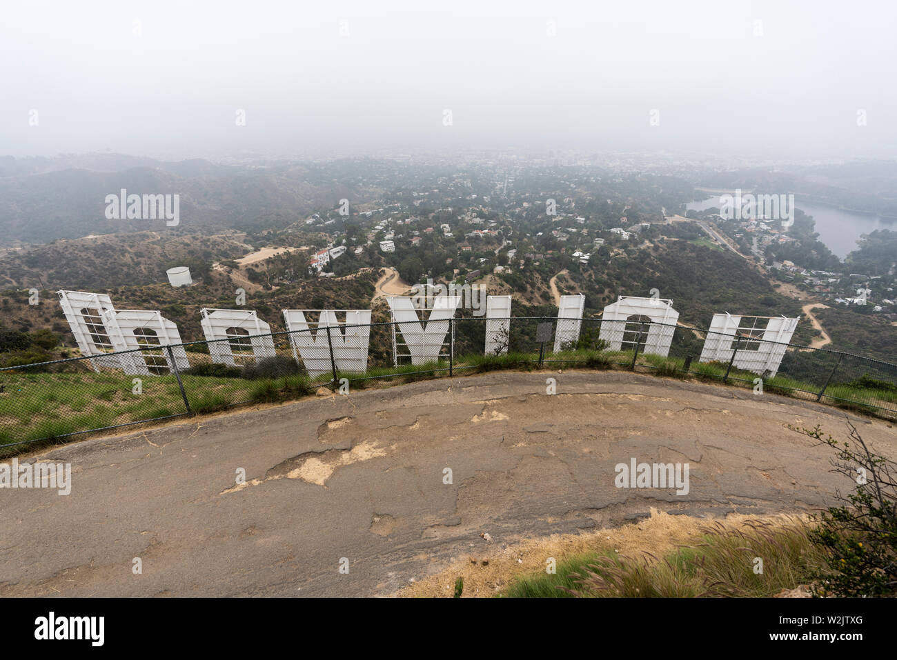Los Angeles, California, USA - July 7, 2019:  Foggy morning view behind the famous Hollywood Sign in popular Griffith Park. Stock Photo