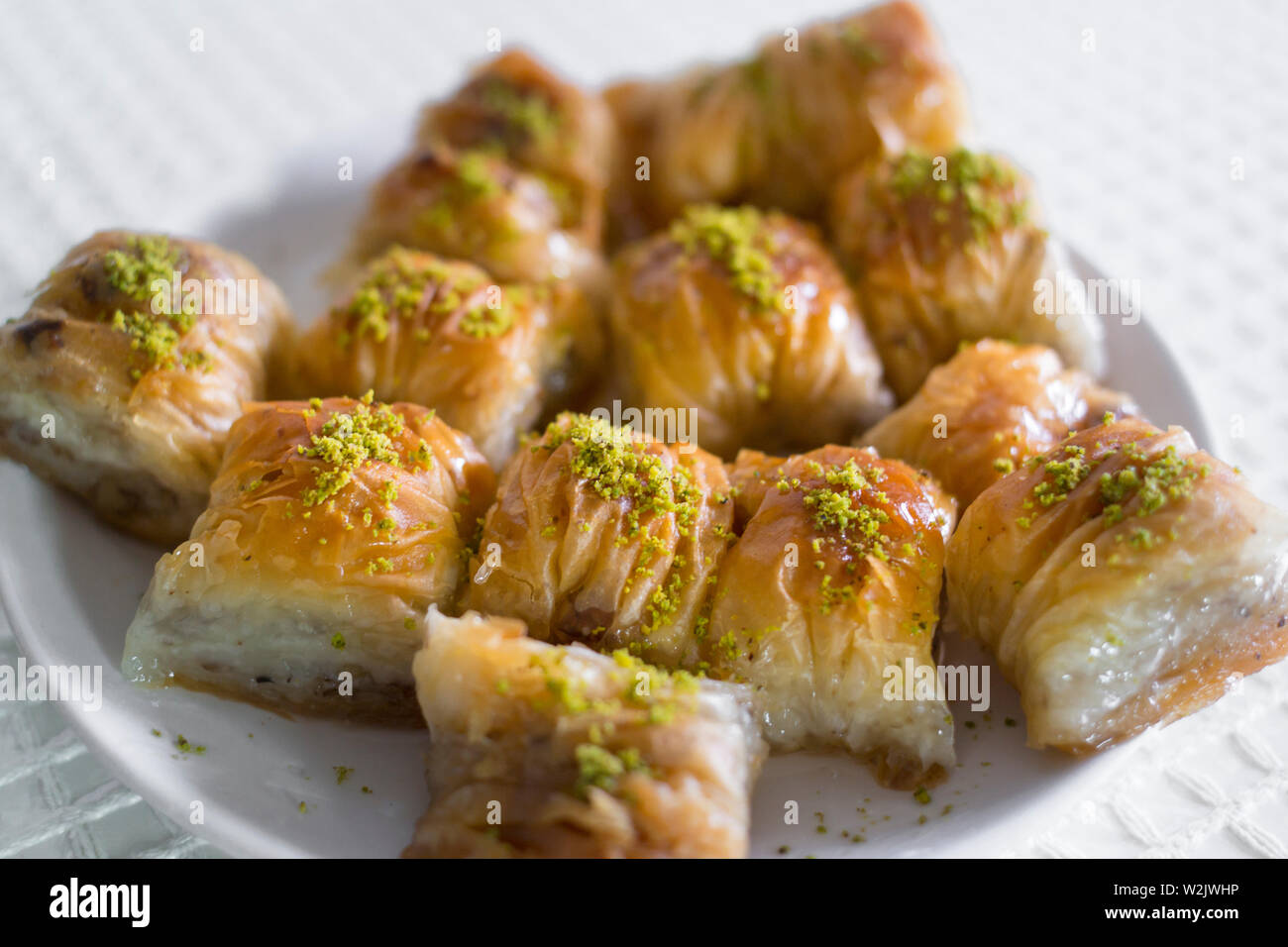 homemade turkish baklava dessert in plate with green pistachio Stock Photo
