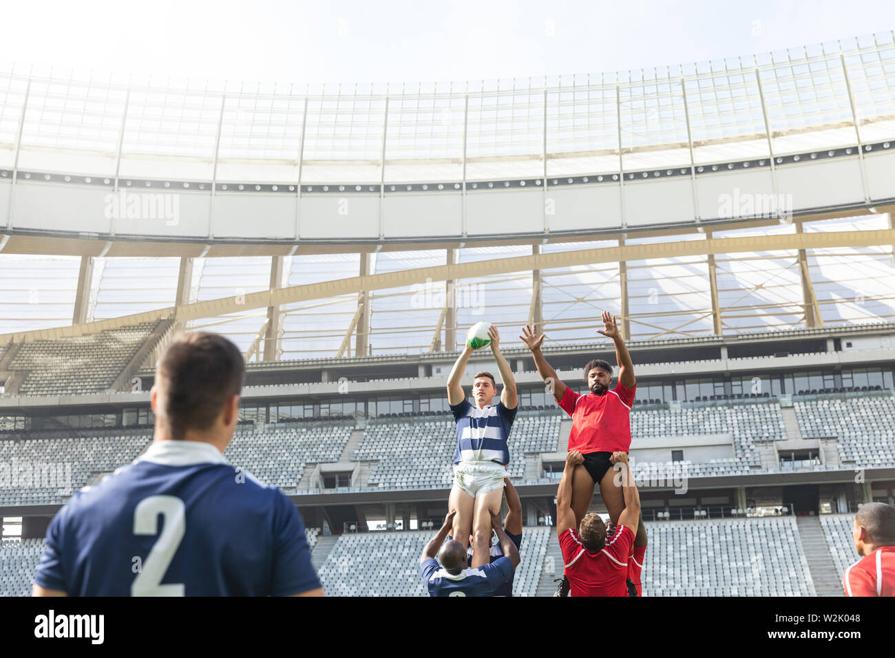 Male rugby players playing rugby match in stadium Stock Photo - Alamy