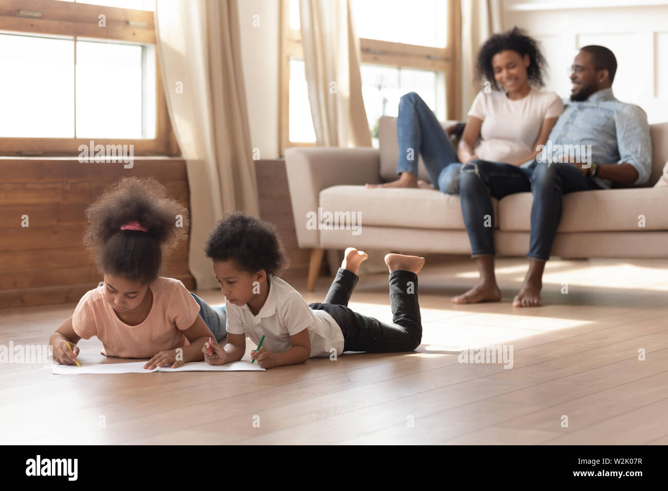 Happy african family with kids leisure activities in living room Stock Photo