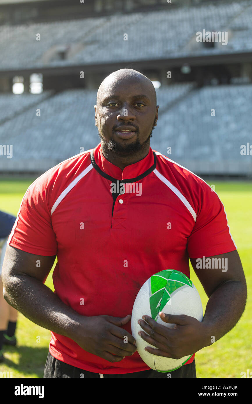Rugby player standing with rugby ball in the stadium Stock Photo Alamy