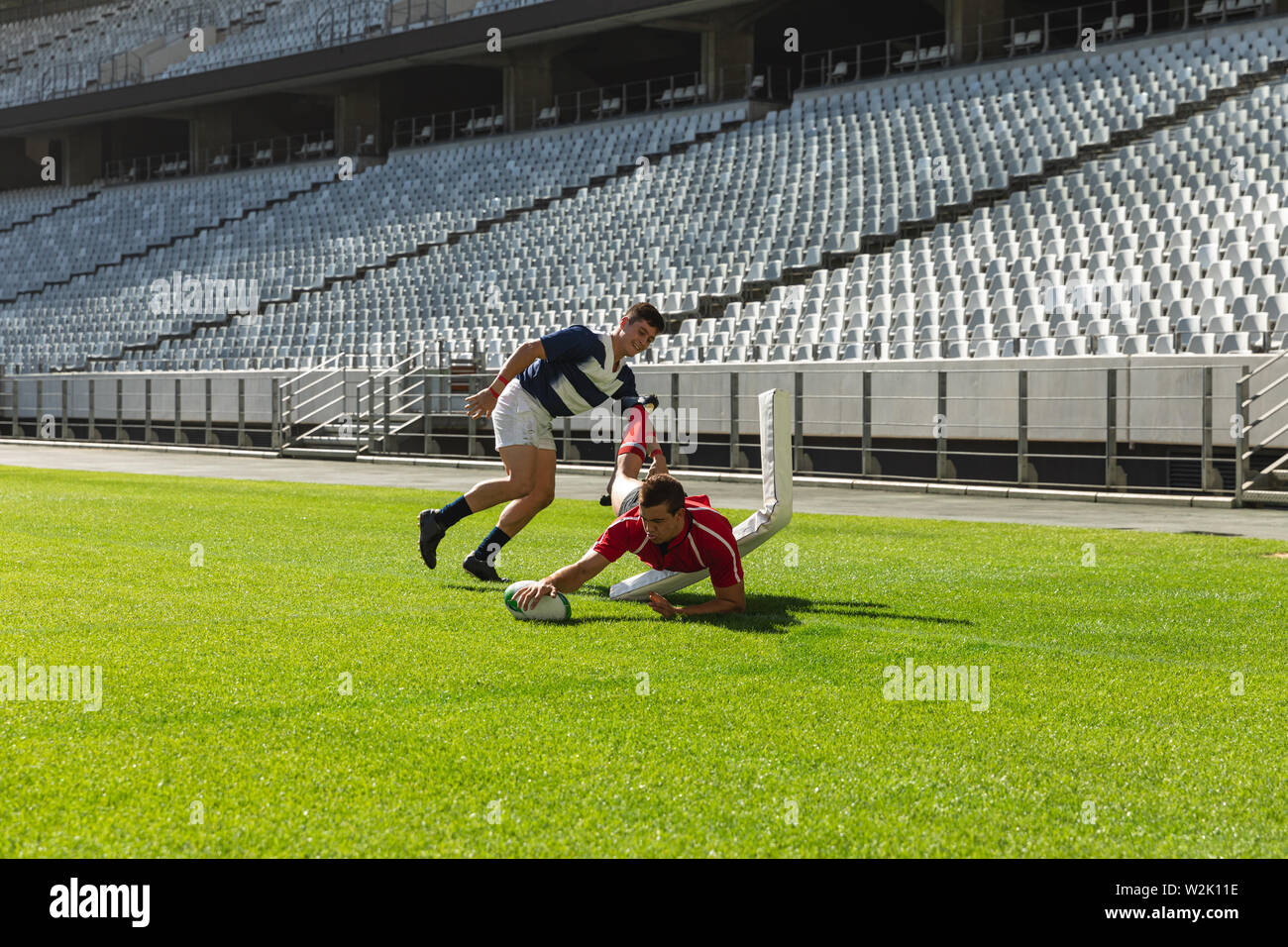 Male rugby players playing rugby match in stadium Stock Photo - Alamy