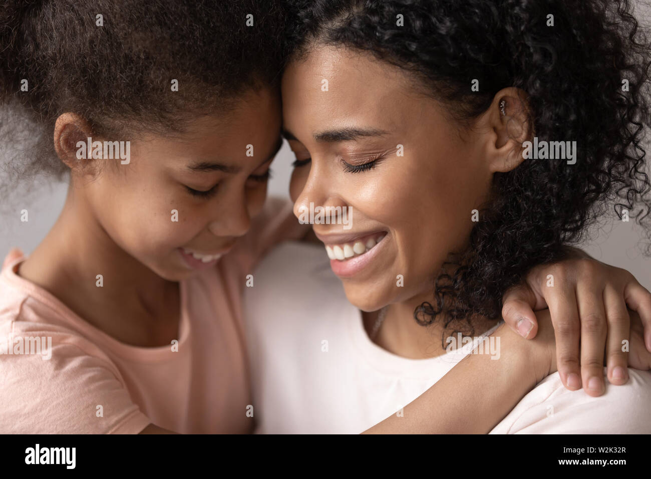 Loving affectionate african mother embrace cute little kid daughter Stock Photo