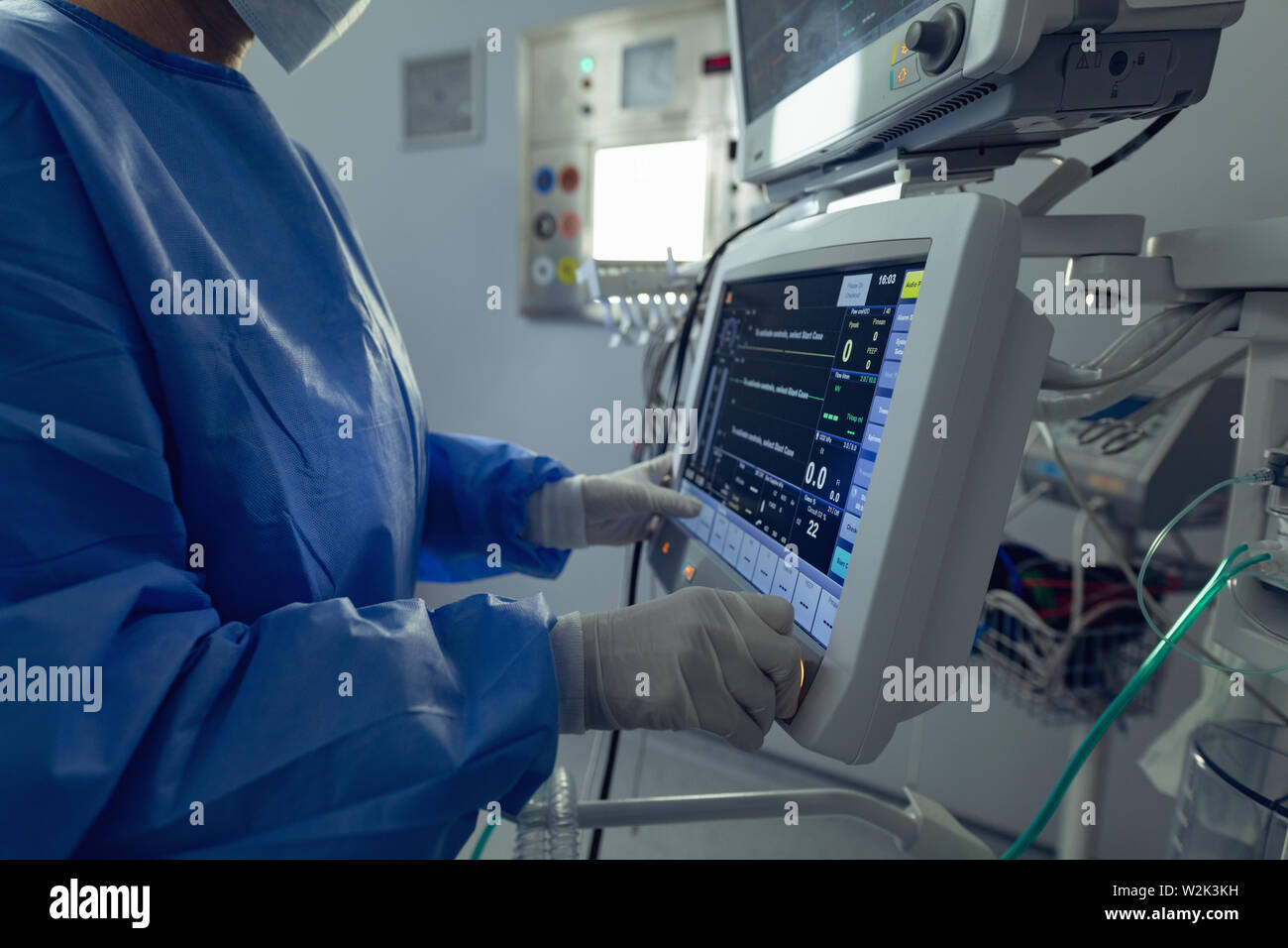 Surgeon Using Monitor Surgeon using the medical monitor in operation theater at hospital ...