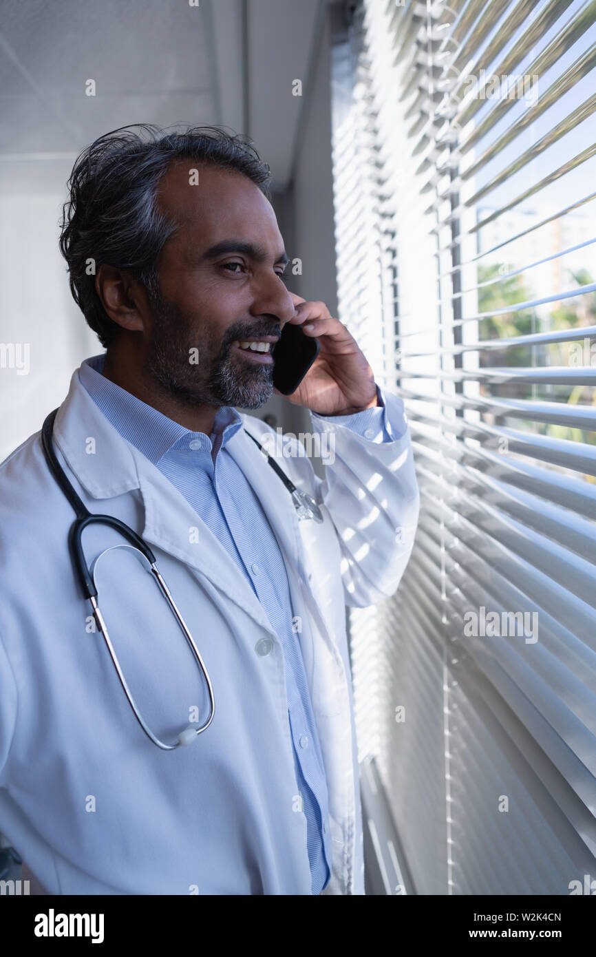 Happy mature male doctor hi-res stock photography and images - Alamy