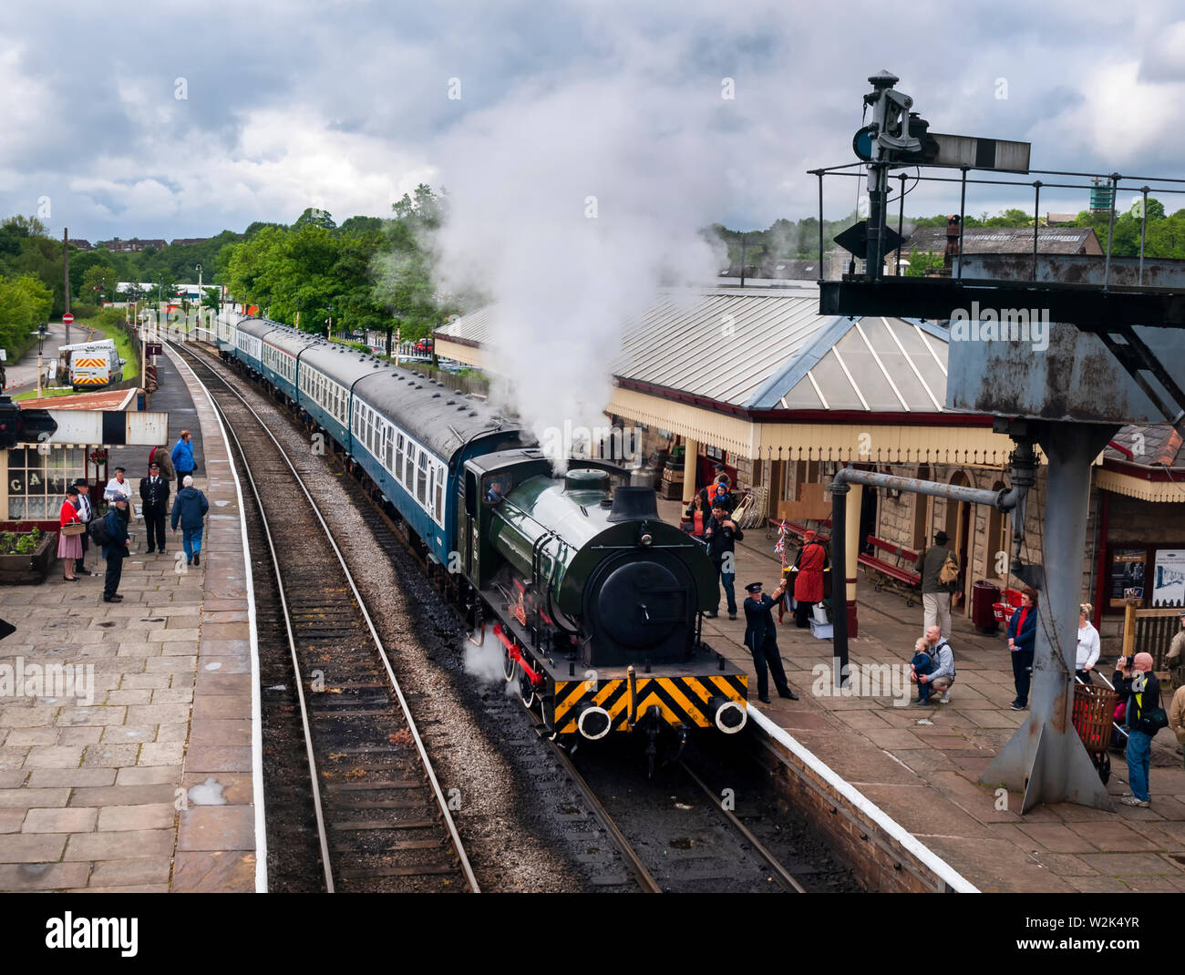 East Lancashire Railway on the platform at Ramsbotton railway station Bury England 25 May 2014. Showing a steam train pulling in at the station with p Stock Photo