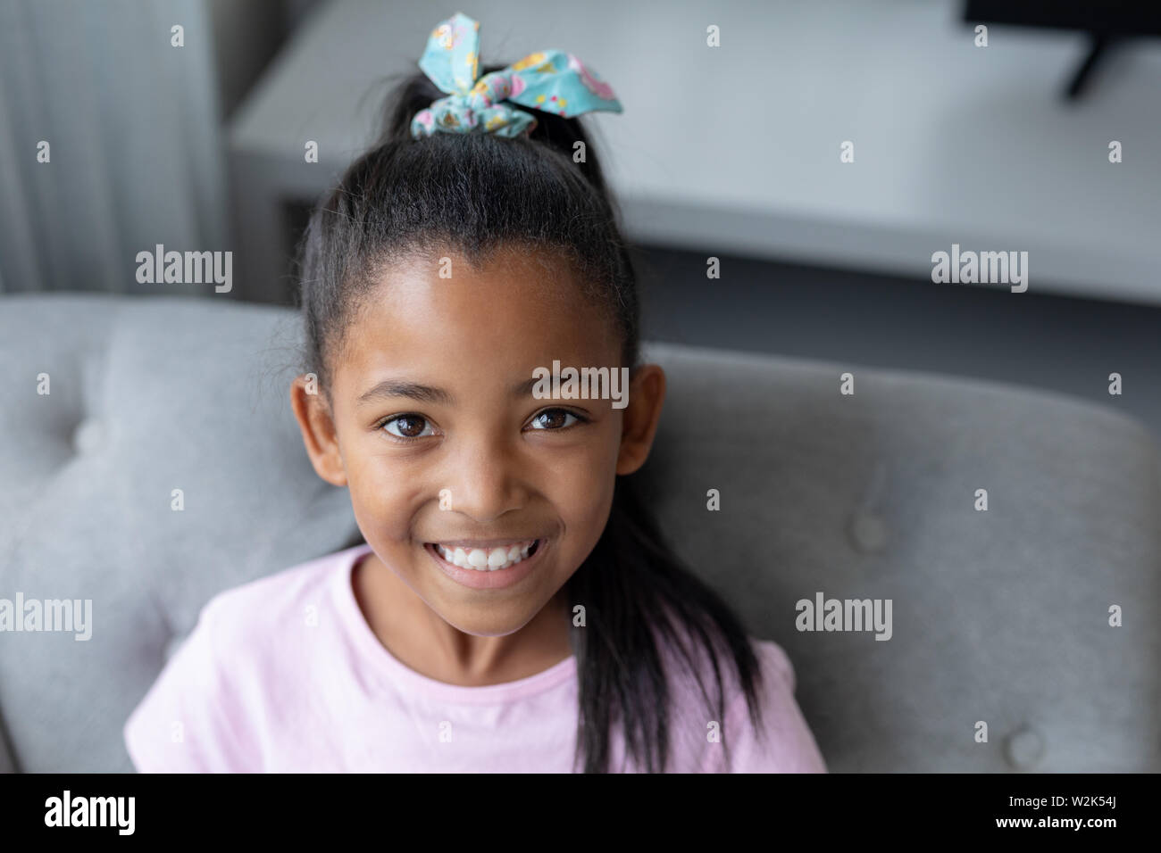 Girl relaxing on a sofa in living room at home Stock Photo