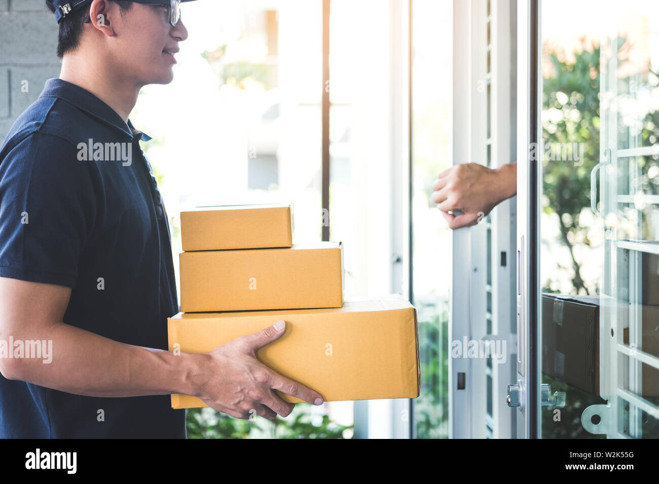 Home Owner Open Door To Delivery Man Standing With Parcels In Hands Outdoors Home Delivery Service And Working With Service Mind Stock Photo Alamy