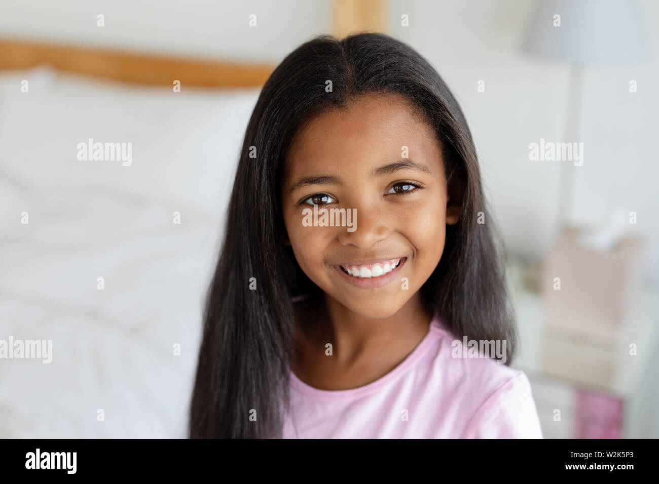 Girl standing in bedroom at home Stock Photo
