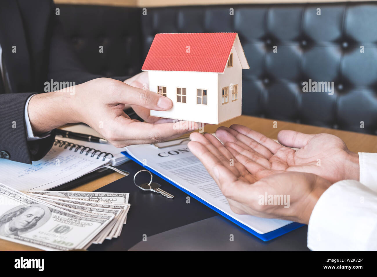 Estate agent sending house model to client after signing agreement ...