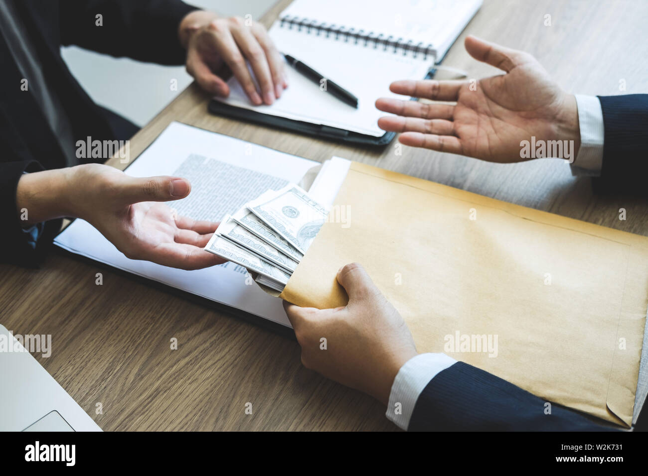 Dishonest cheating in business illegal money, Business man giving bribe money in business people to accept agreement contract of investment deal, Brib Stock Photo