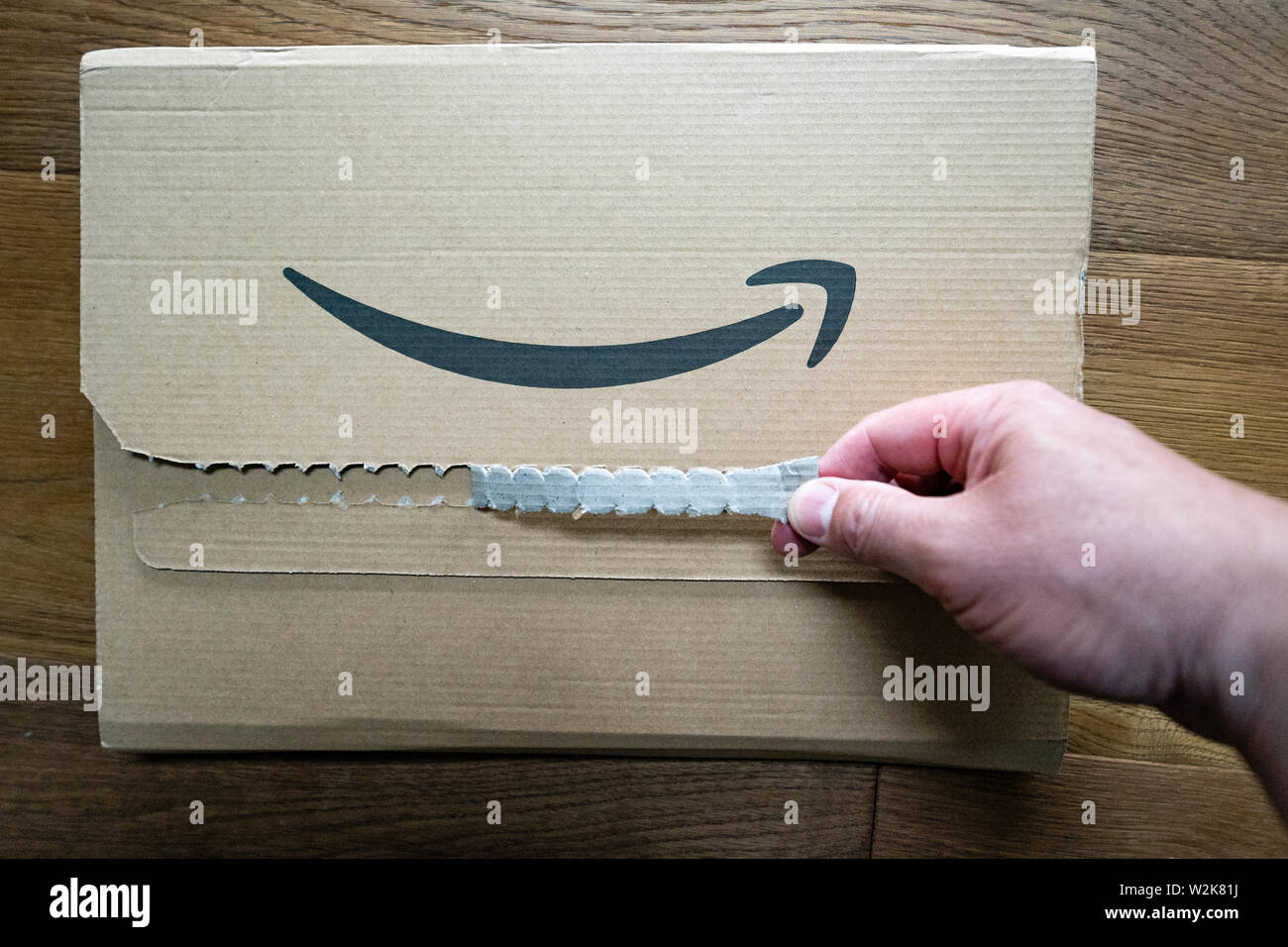 Person opening an Amazon packet Stock Photo