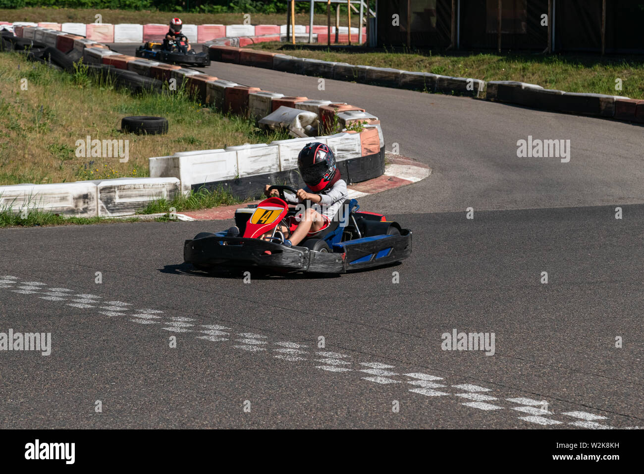 Young Racer At Go Kart Racetrack Circuit Championship Crossing The