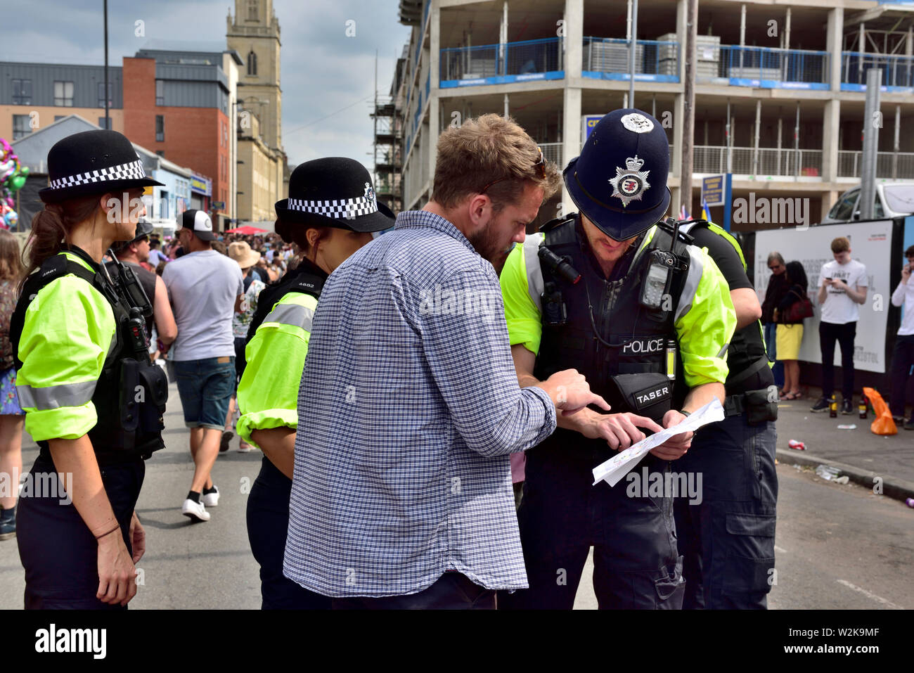 Police helping man with map and directions Stock Photo