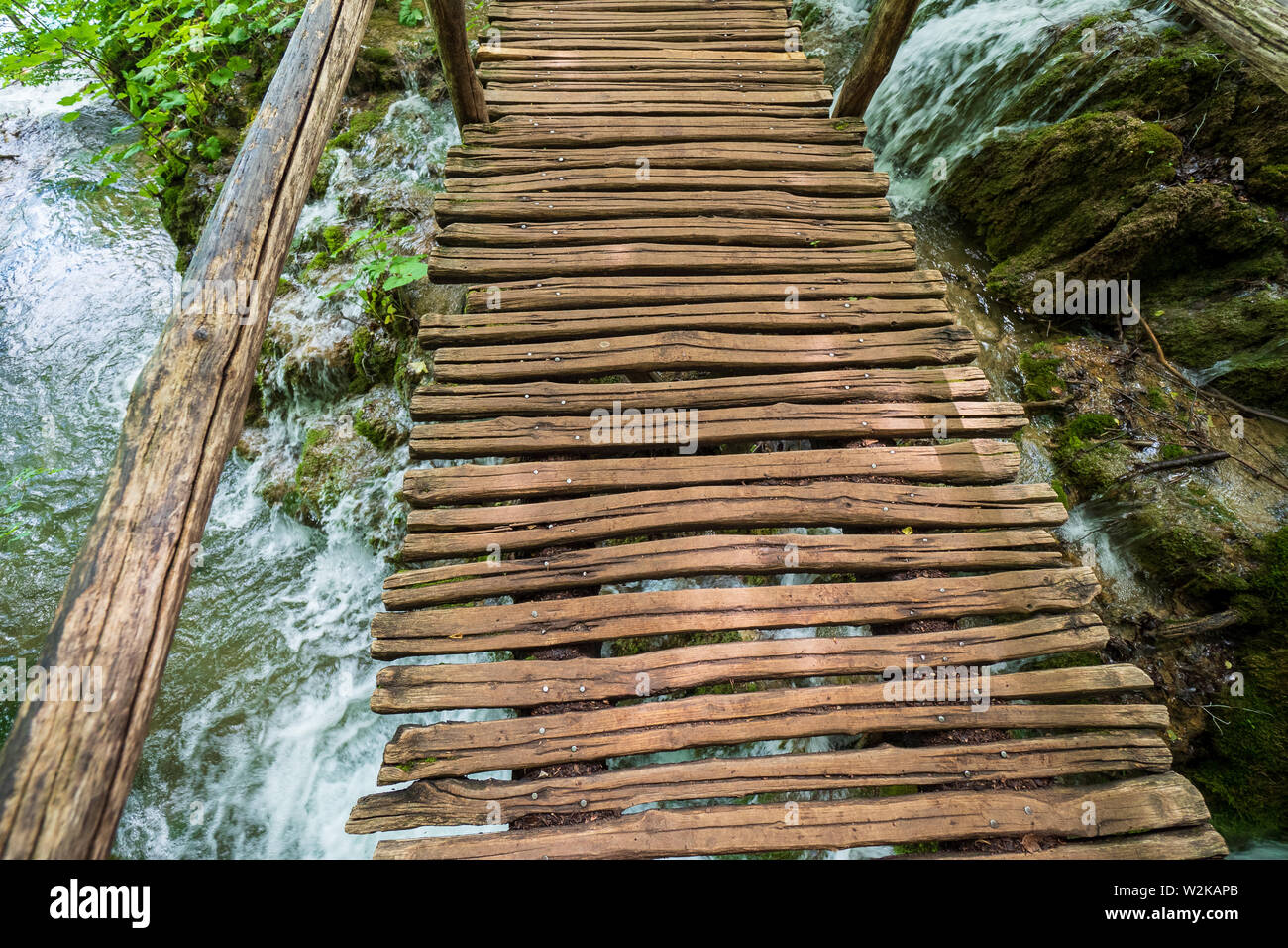 Makeshift wooden bridge over water Stock Photo - Alamy
