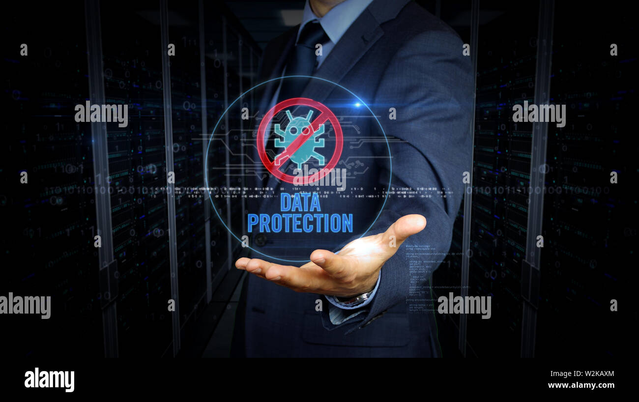 A businessman in suit touch the screen with antivirus symbol hologram. Man using virtual interface. Firewall, computer protection, online safety and c Stock Photo