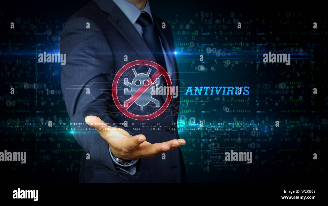 A businessman in suit touch the screen with antivirus symbol hologram. Man using virtual interface. Firewall, computer protection, online safety and c Stock Photo