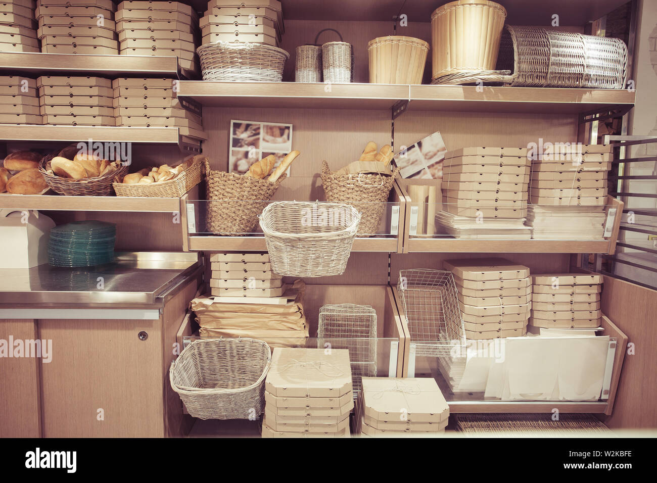Bread in baskets. Pizza delivery boxes on shelves. Modern restaurant