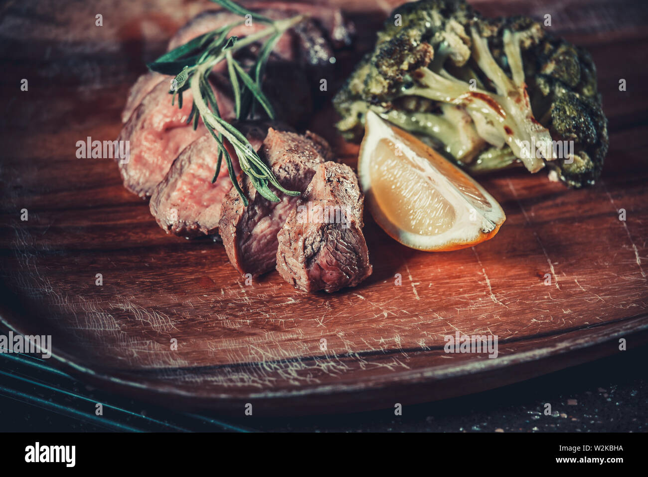 Delicious appetizer with herbs on wooden table close up Stock Photo