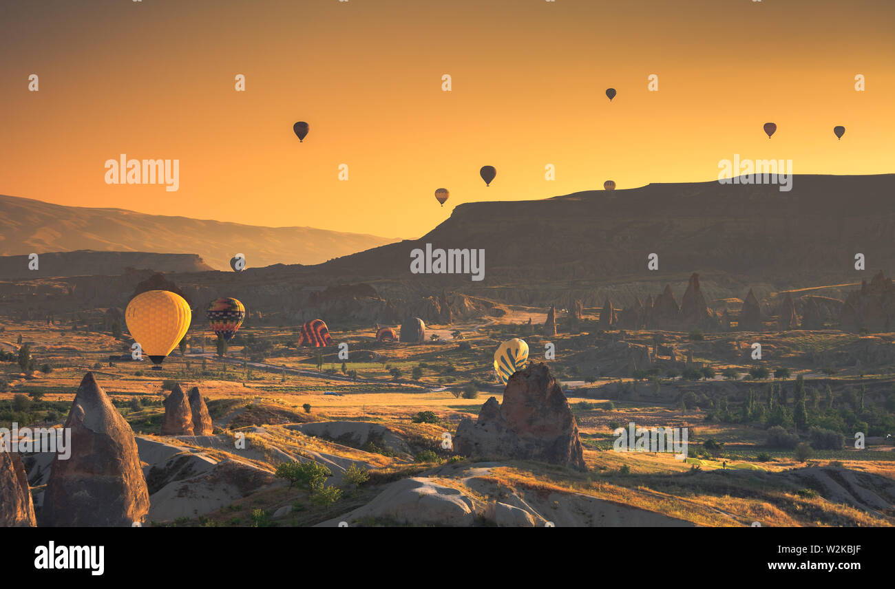 Hot air balloon flying over rock landscape at Cappadocia Turkey Stock Photo