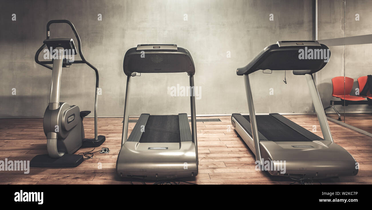 Treadmills exercise machines standing in a row in gym Stock Photo Alamy