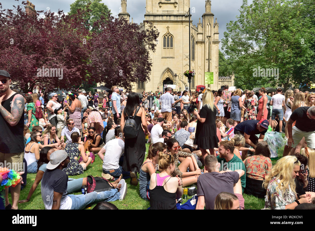 People all ages sitting, standing “hanging about” at summer Bristol St Pauls Carnival festival, Portland Square, UK Stock Photo