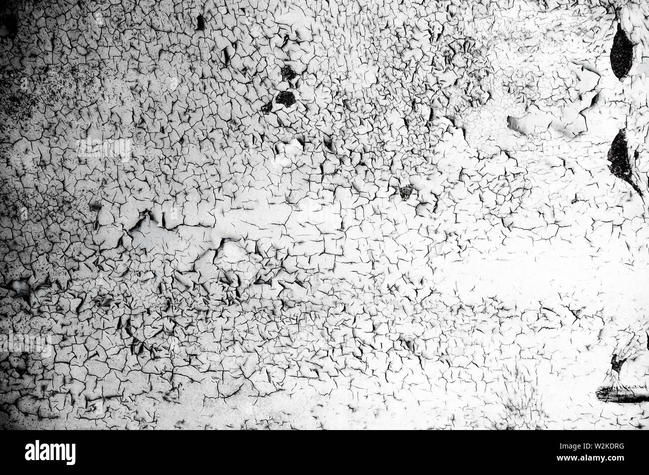 Cracking and peeling paint on a wall. Gray background Stock Photo