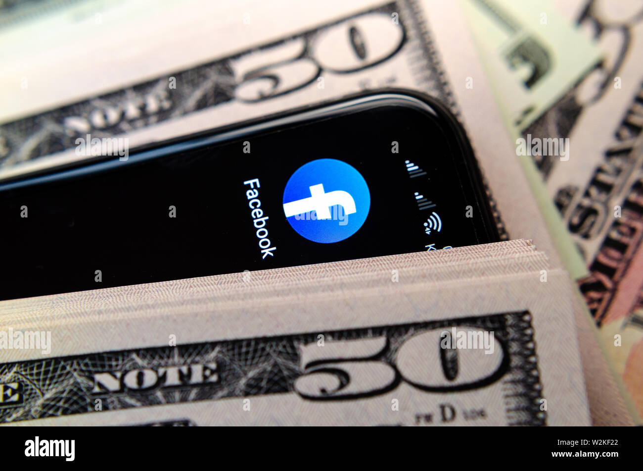Facebook app icon and 50 dollar banknotes. Illustrate the news about ...