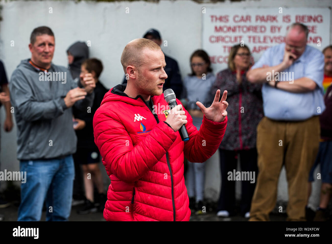 Jamie Bryson addressing supporters of the 11th Night bonfire at Avoniel Leisure Centre in Belfast, Northern Ireland, to mark the anniversary of the Battle of the Boyne. Stock Photo