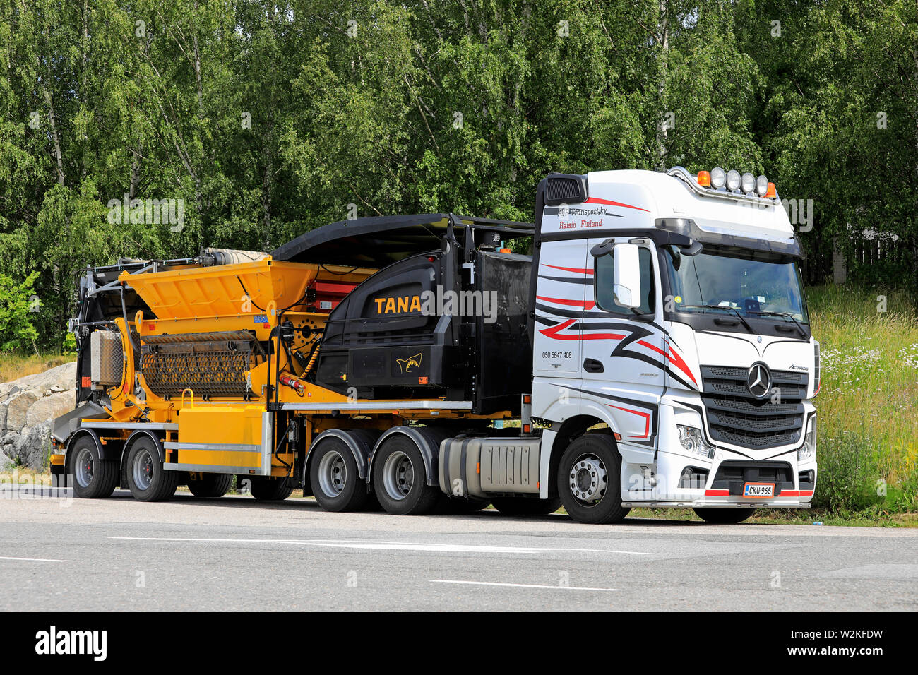 Salo, Finland. June 29, 2019. Mercedes-Benz Actros 2653 truck of AJP Transport Ky hauling TANA Shark waste shredder parked on a truck stop yard. Stock Photo