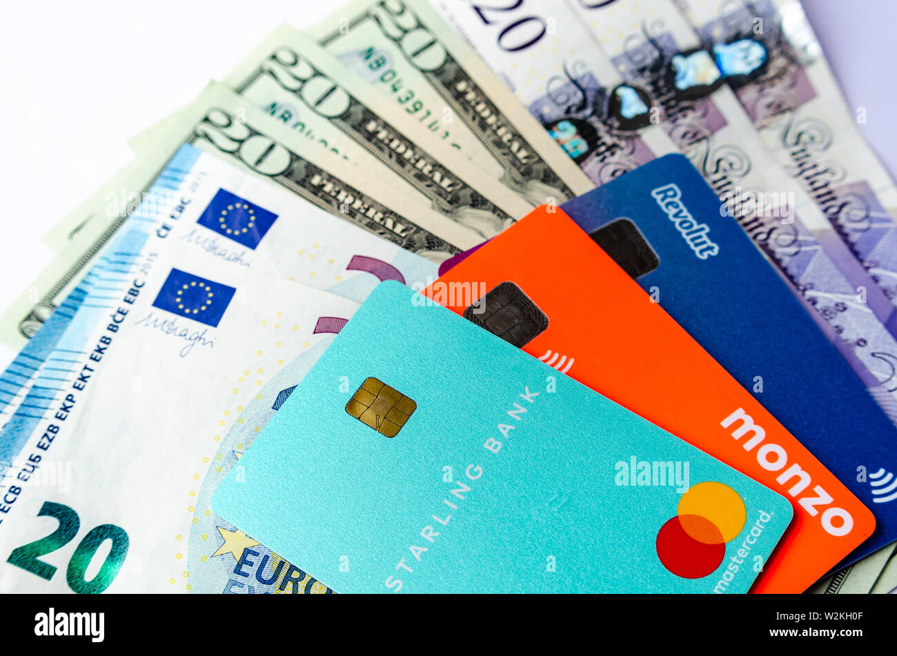 Starling, Monzo, Revolut bank cards on the cash of different countries. Cards with no fee for money exchange and multicurrency account. Stock Photo