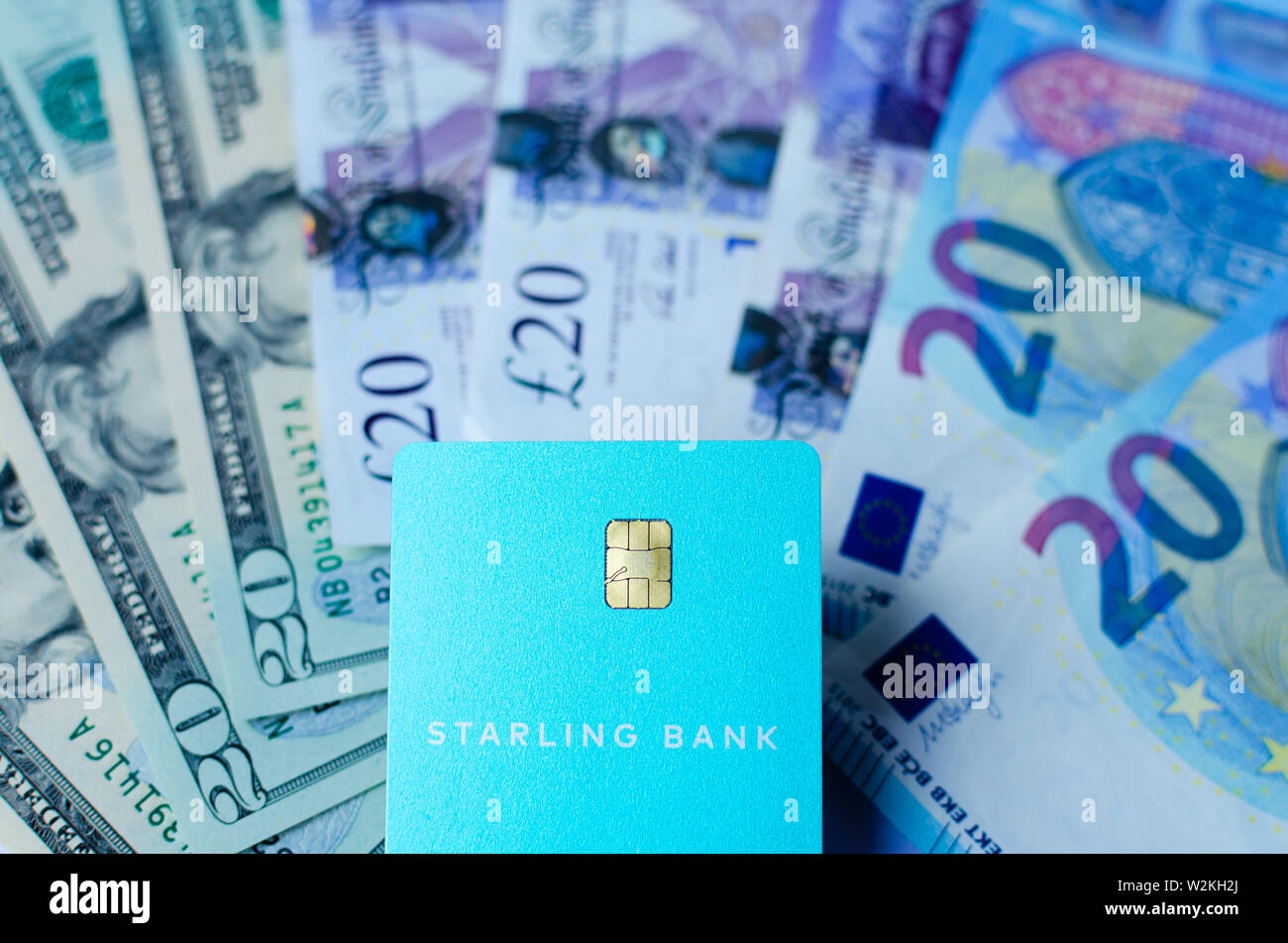 Starling bank card on the cash of different countries. Card with no fee for money exchange is perfect for travel. Stock Photo