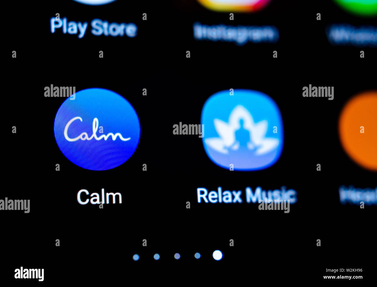 Calm app icon on the smartphone. Macro photo. App that helps to ease anxiety and stress. Stock Photo