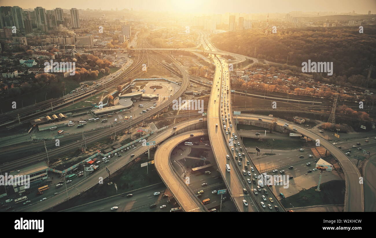 City Road System with Sight Traffic Jam Aerial View. Urban Congested Highway Lane Transport Navigation Scene. Busy Downtown Building Vehicle at Sunset. Travel Concept Drone Flight Shot Stock Photo