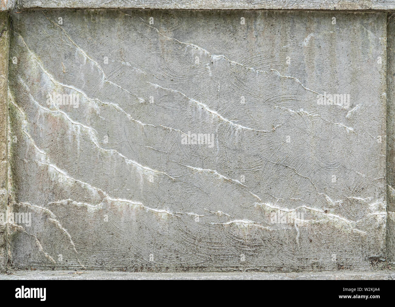a pattern of deterioration on the cement used to make a wall outside on a bridge Stock Photo