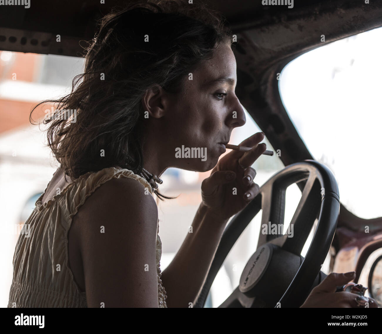 Woman smoking cigarette in car hi-res stock photography and images