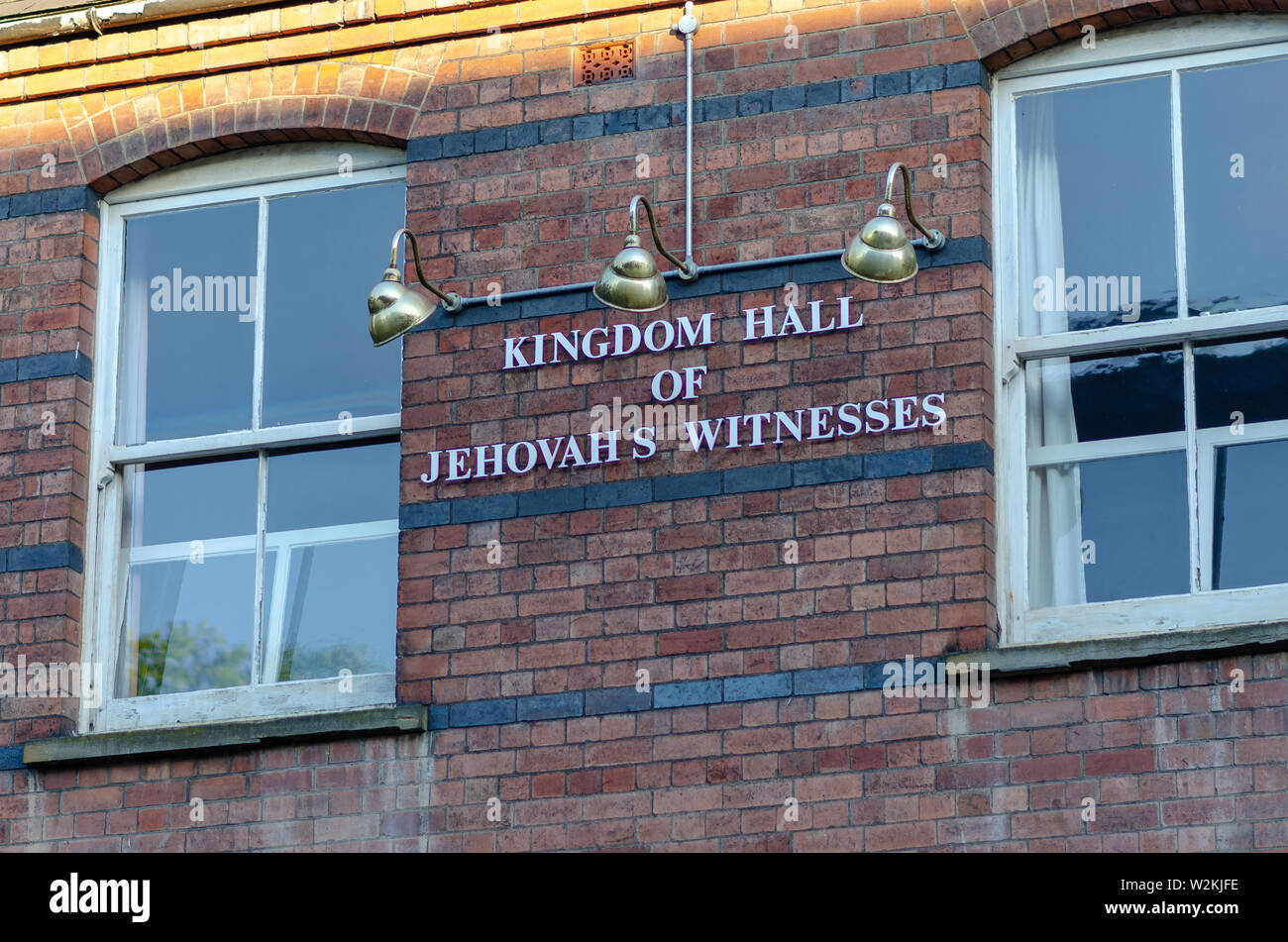 KINGDOM HALL OF JEHOVAH'S WITNESSES sing on a brick building in small English town called Stone. Stock Photo