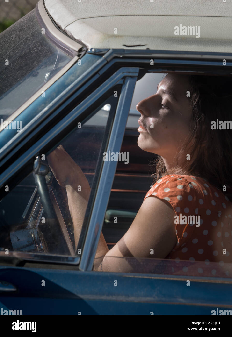an attrrative young woman sitting in a car Stock Photo