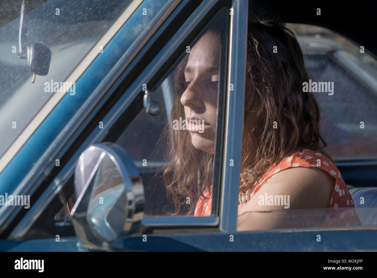 an attrrative young woman sitting in a car Stock Photo